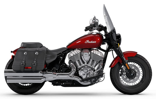 A red and black Indian Super Chief cruiser motorcycle with a large windshield, black saddlebags, and chrome exhaust pipes, shown in a side profile on a white background.