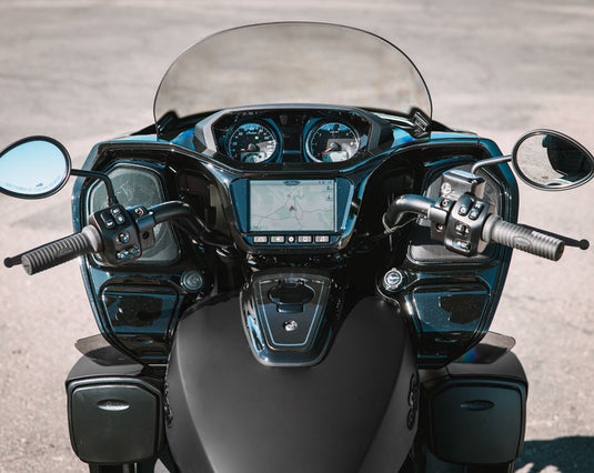 Close-up front view of a black 2026 Indian Roadmaster Limited motorcycle with a clear windshield, dual mirrors, instrument gauges, and a central digital display, photographed outdoors on a paved surface.