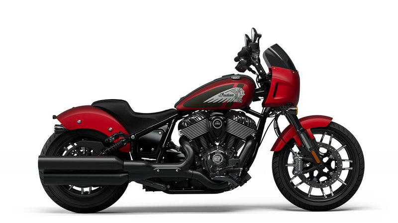 Load image into Gallery viewer, A red and black Indian Sport Chief cruiser motorcycle with a windscreen and chrome details, shown in a side profile on a white background.
